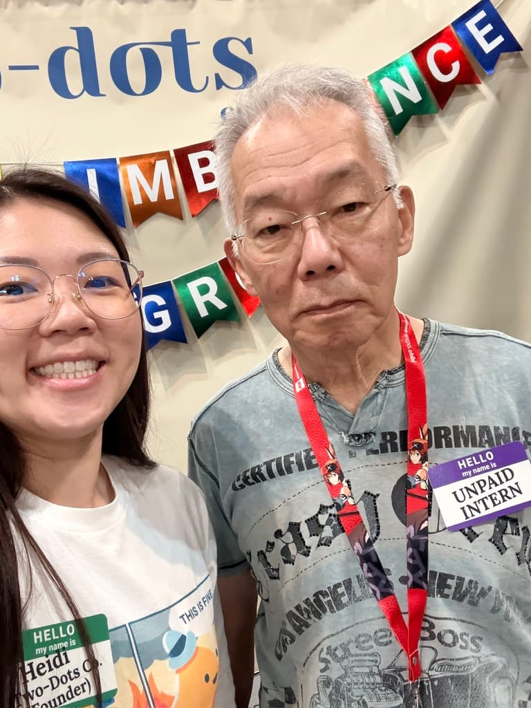 Heidi and her dad, the unpaid intern, at the booth